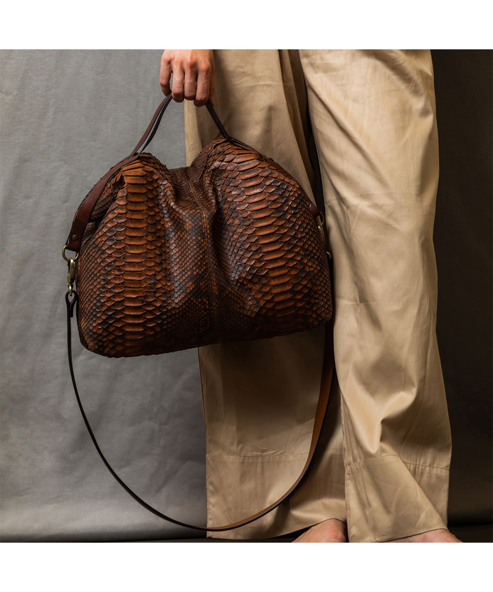 Large and very light handbag in genuine python skin in camel color.