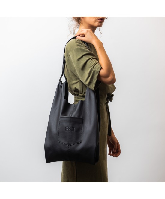 Soft and lightweight leather bag with adjustable strap that mimics plastic shopping bags.