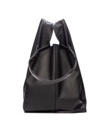 Soft and lightweight leather bag with adjustable strap that mimics plastic shopping bags.