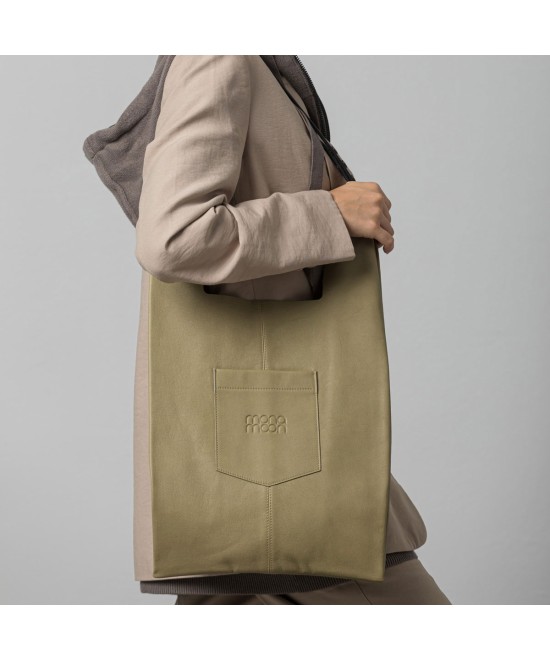 Soft and lightweight leather bag with adjustable strap that mimics plastic shopping bags.
