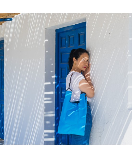 Soft and lightweight leather bag with adjustable strap that mimics plastic shopping bags.