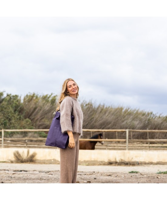 Soft and lightweight leather bag with adjustable strap that mimics plastic shopping bags.