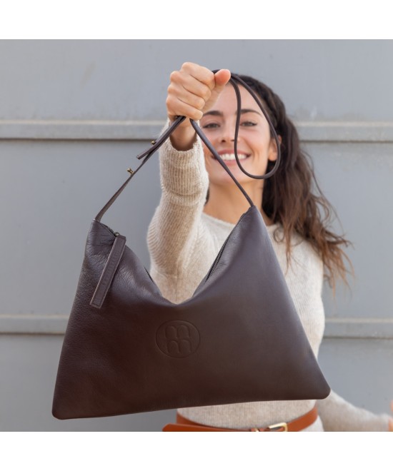 Large leather bag with adjustable strap.