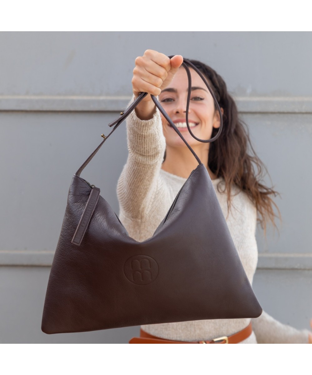 Large leather bag with adjustable strap.