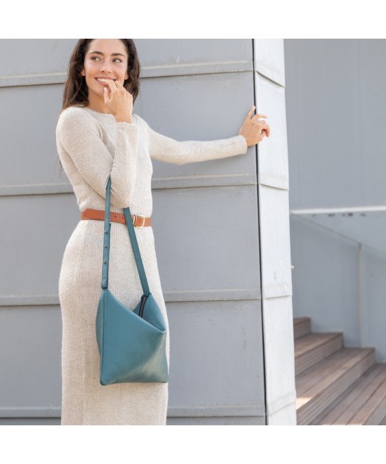 Large leather bag with adjustable strap.