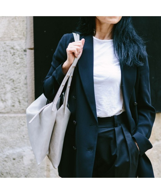 Wide leather bag with two individual departments and adjustable strap.