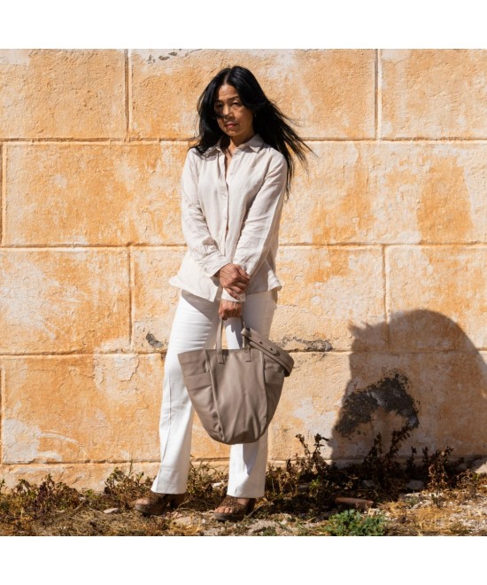 Multi-position bag with outer pockets, short handles and long adjustable strap. Taupe leather
