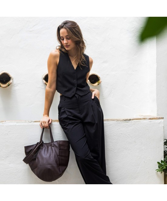 Multi-position bag with outer pockets, short handles and long adjustable strap. Brown leather