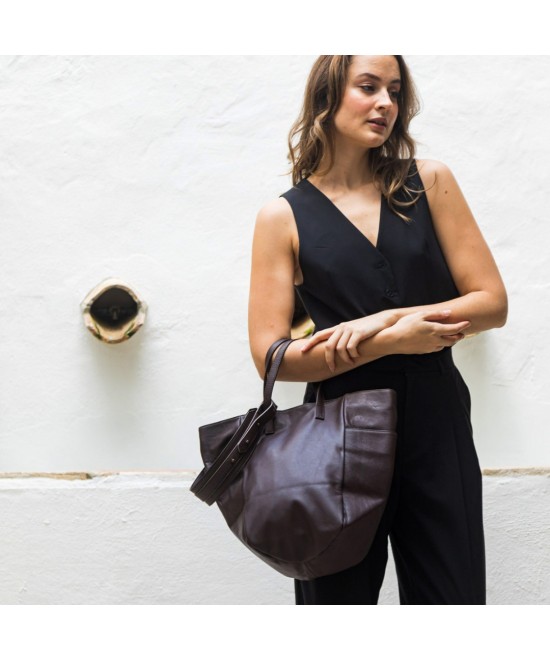 Multi-position bag with outer pockets, short handles and long adjustable strap. Brown leather