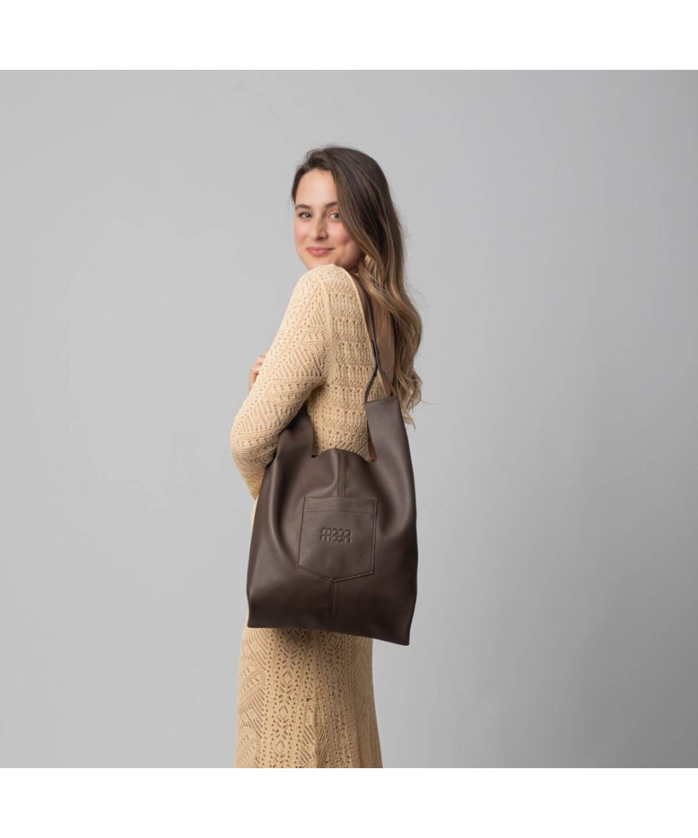 Soft and lightweight leather bag with adjustable strap that mimics plastic shopping bags.