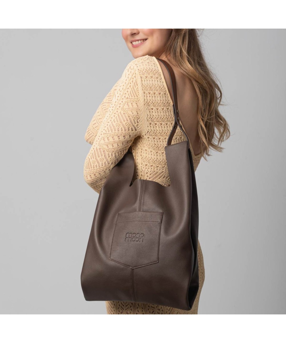 Soft and lightweight leather bag with adjustable strap that mimics plastic shopping bags.