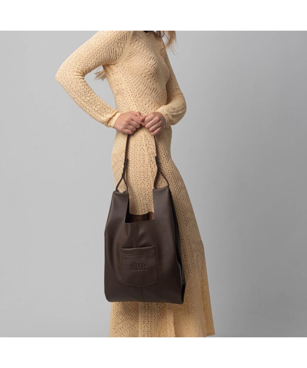 Soft and lightweight leather bag with adjustable strap that mimics plastic shopping bags.