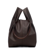 Soft and lightweight leather bag with adjustable strap that mimics plastic shopping bags.